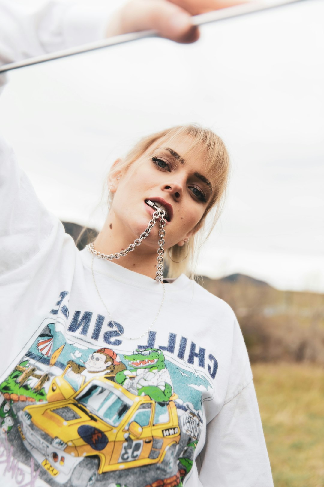 woman in white crew neck t-shirt with silver necklace