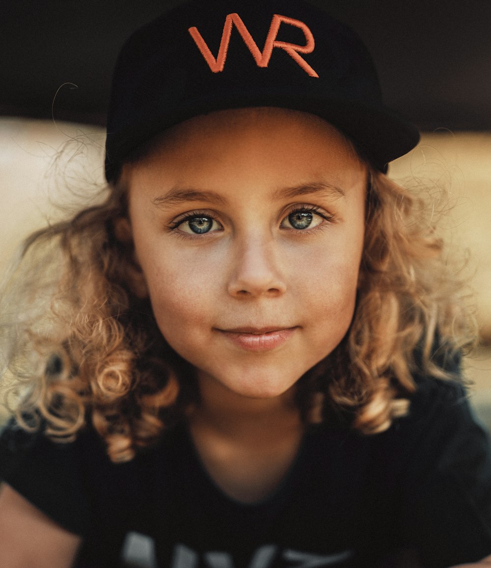 woman in black and red new york yankees fitted cap