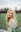 woman in white lace shirt standing on green grass field during daytime