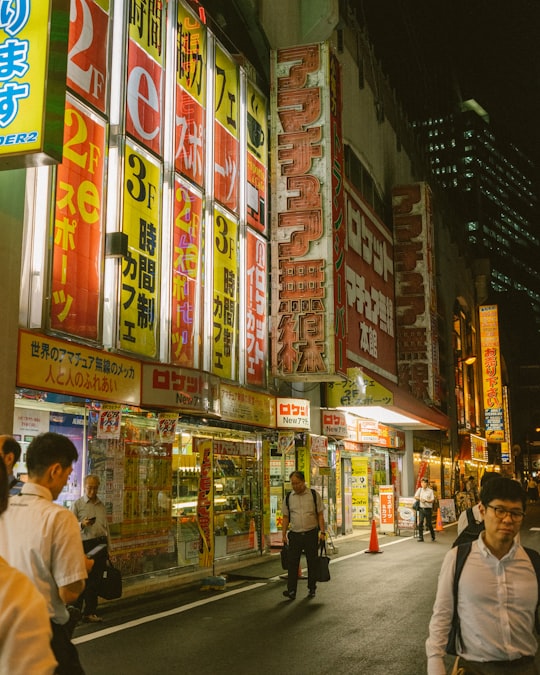 people walking on street during night time in Akihabara Japan