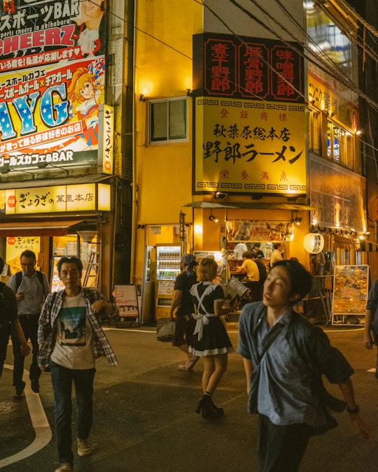 people walking on street during nighttime in Yaro Ramen Japan