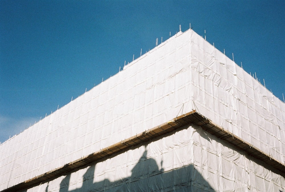 white concrete wall under blue sky during daytime