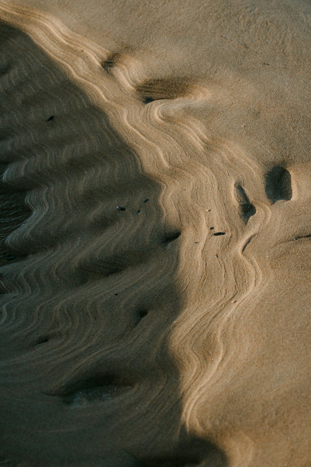 brown sand with water during daytime