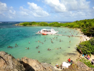 Guests swimming and relaxing at the Ilha do Macuco during a stop on the pirate tour.