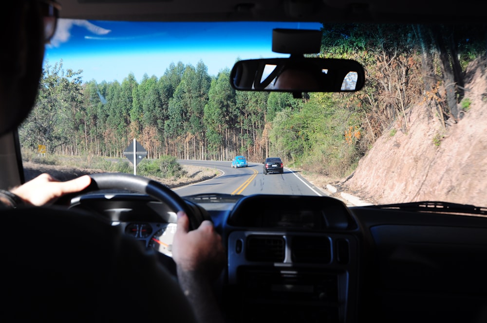 man driving a car on a road