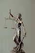 woman in gold dress holding sword figurine