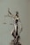 woman in gold dress holding sword figurine