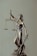 woman in gold dress holding sword figurine