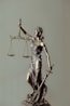 woman in gold dress holding sword figurine