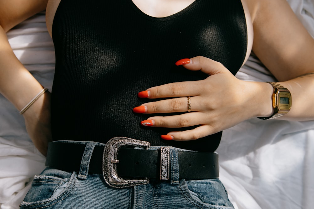 woman in black tank top and blue denim bottoms