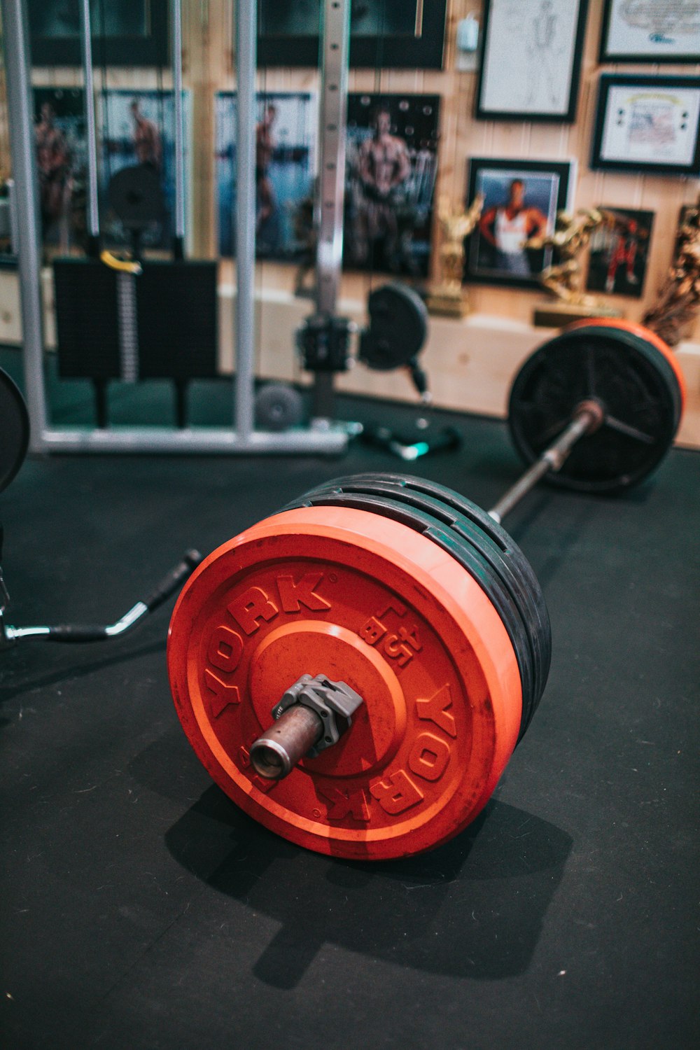 red and silver dumbbell on black surface