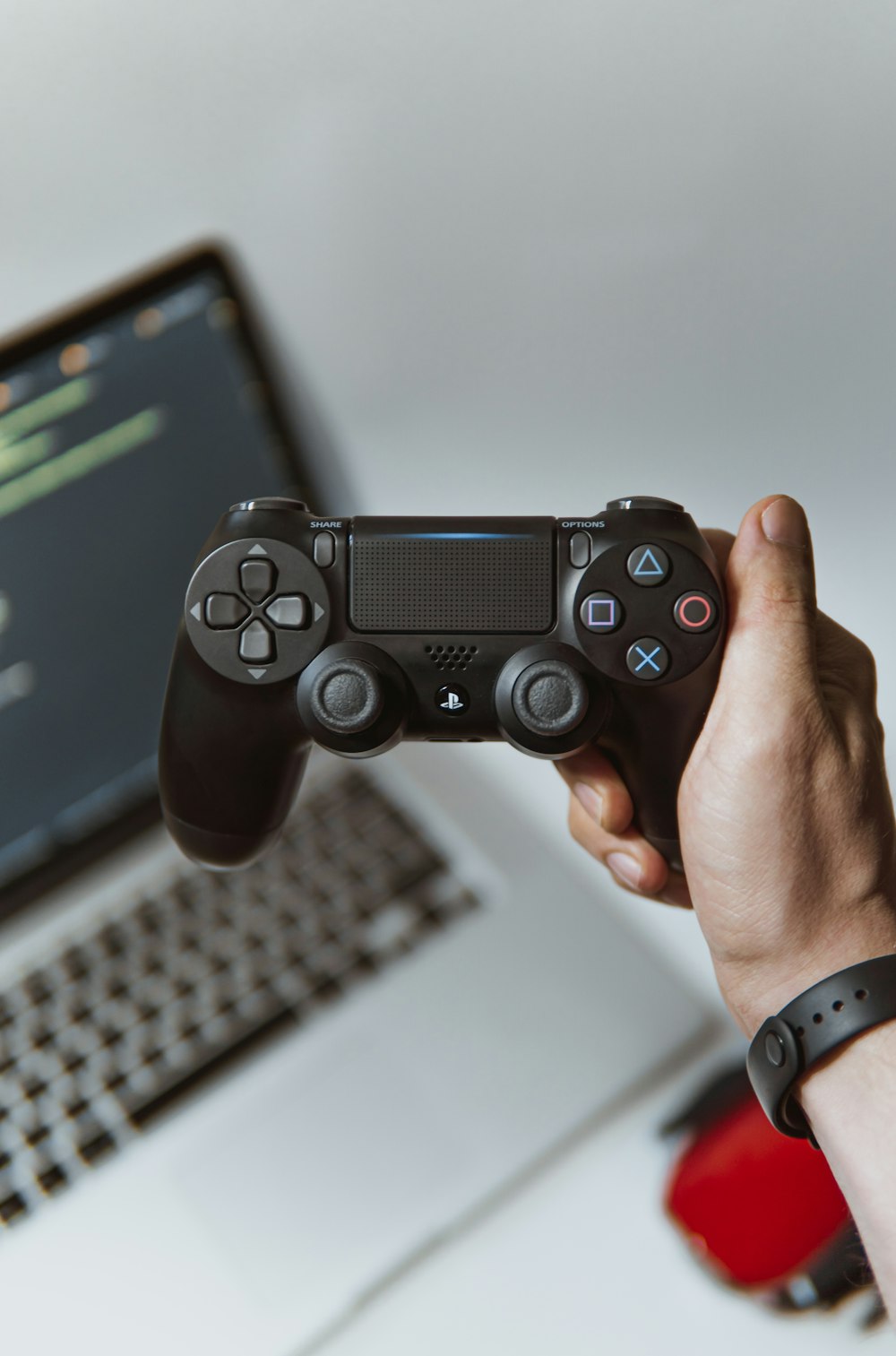 person holding black sony ps 4 game controller