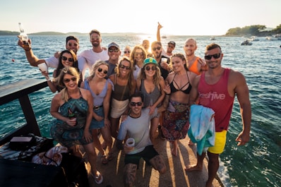 group of people standing on beach during daytime