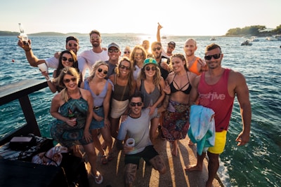 group of people standing on beach during daytime