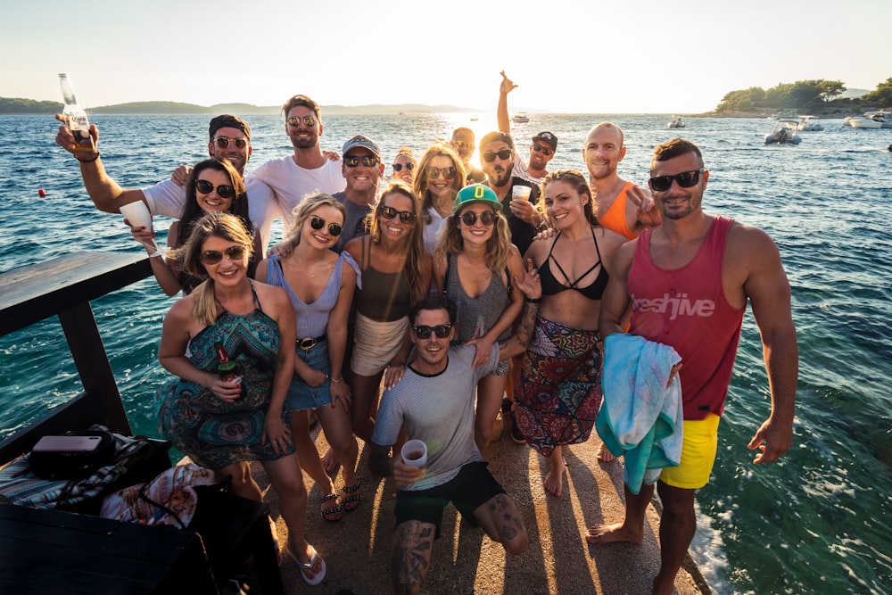 group of people standing on beach during daytime