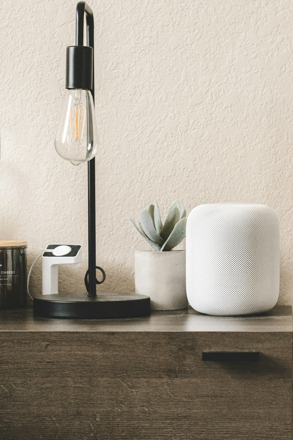 black and white table lamp beside white ceramic mug