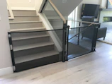 Staircase with a neatly installed safety net blending with the modern decor.