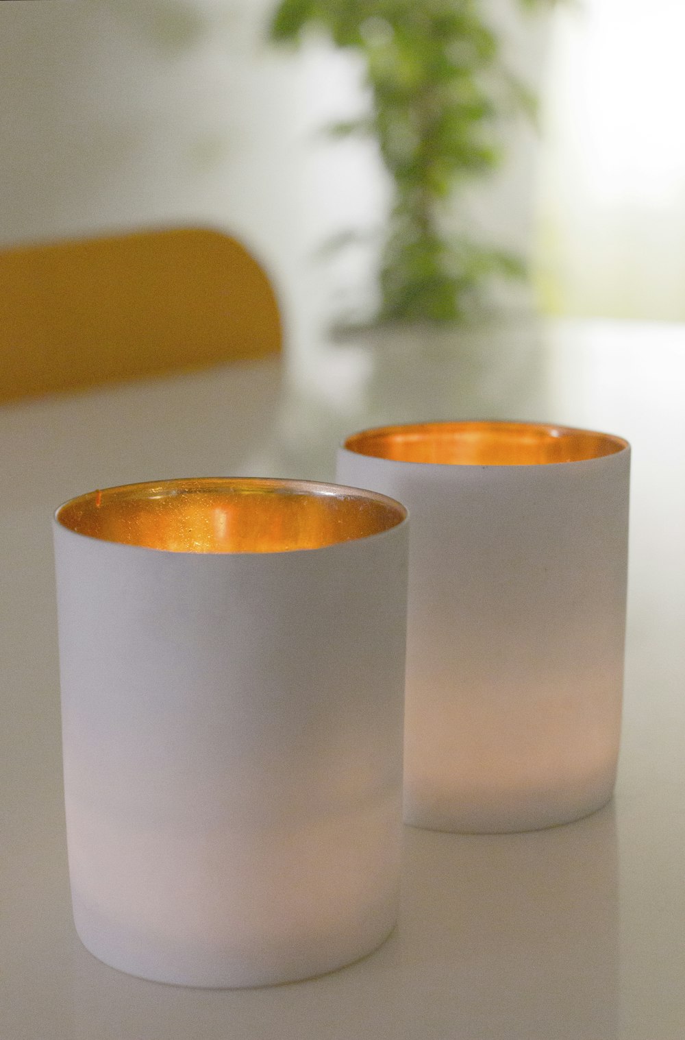 white pillar candles on brown wooden table