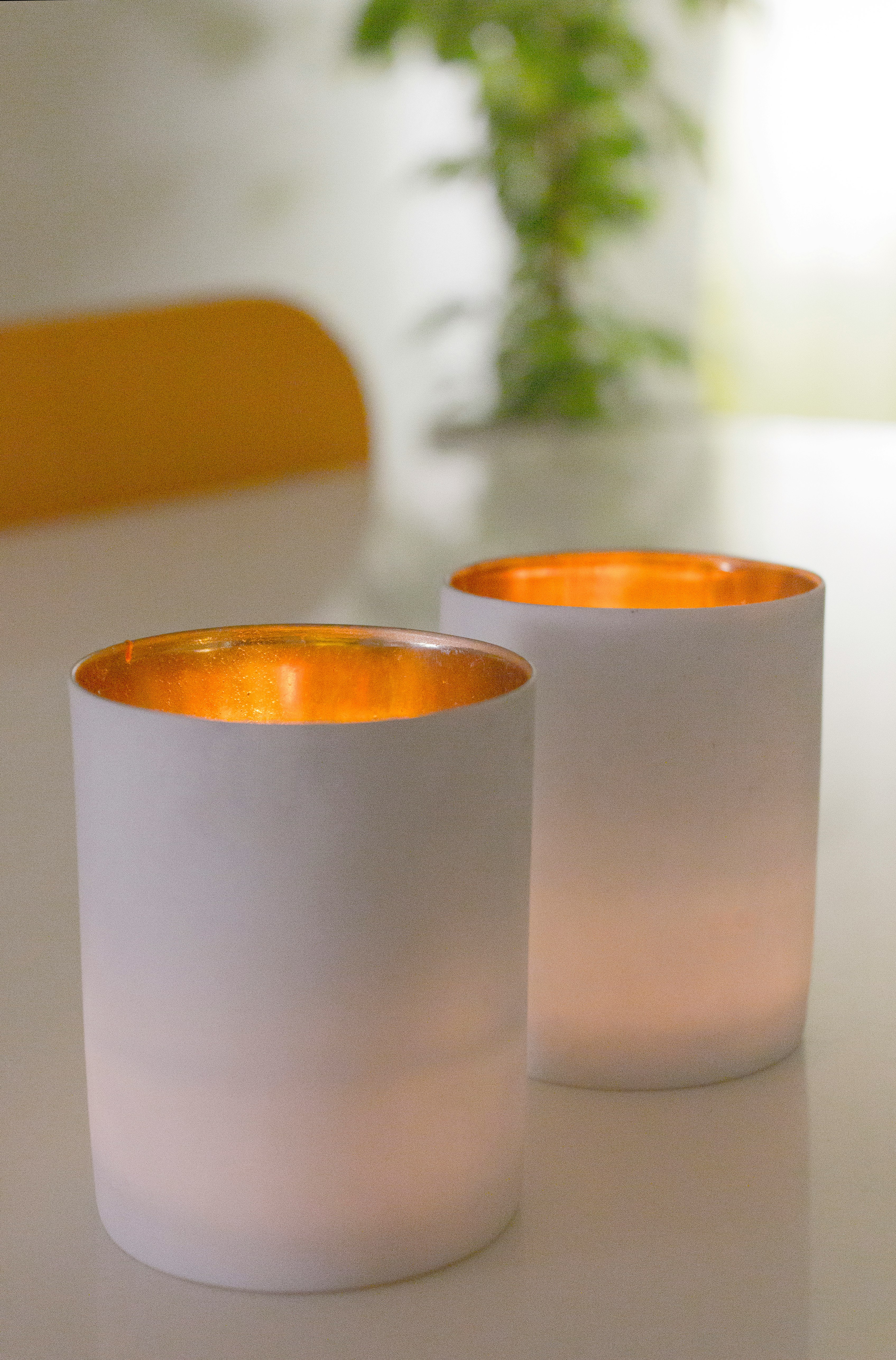 white pillar candles on brown wooden table