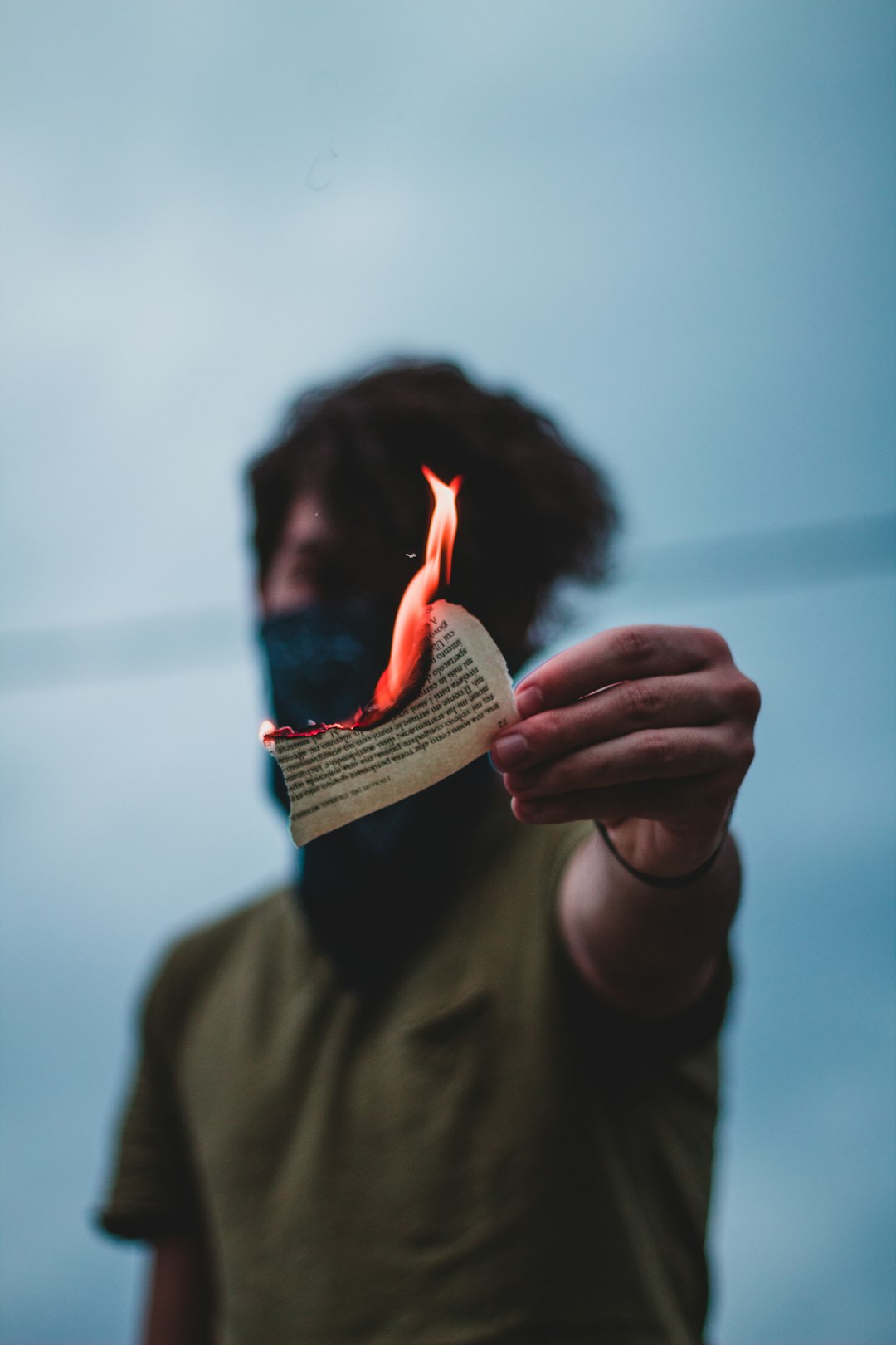 person holding a book with fire