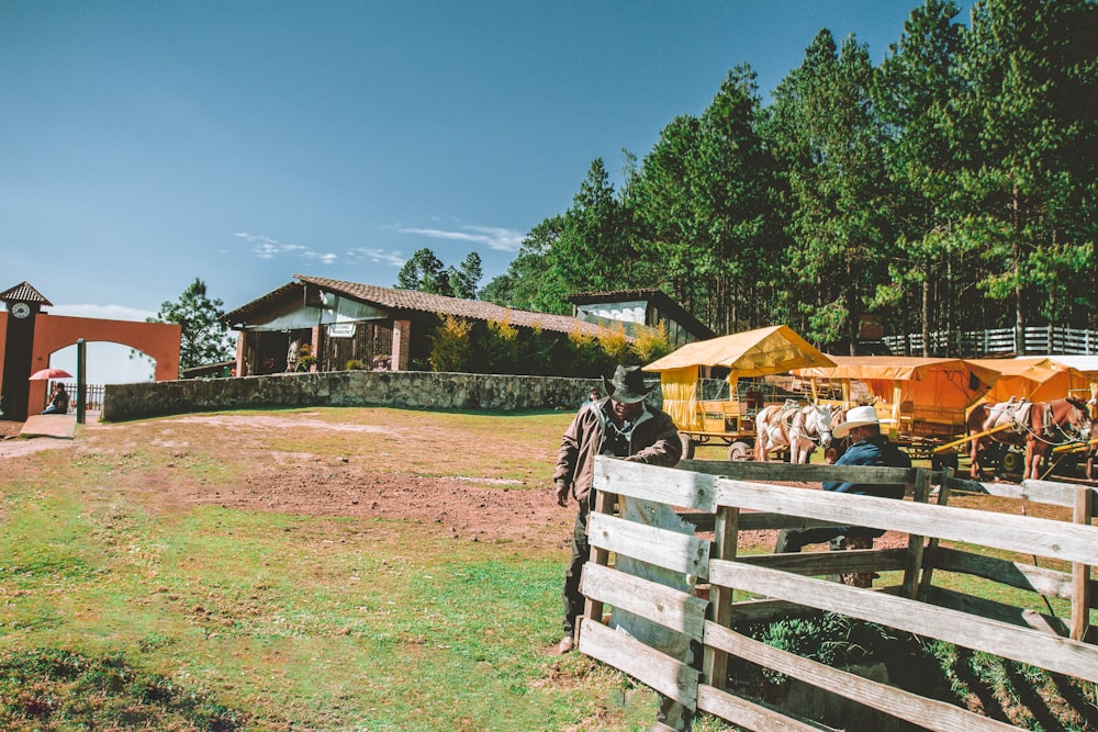 brown wooden fence on green grass field during daytime