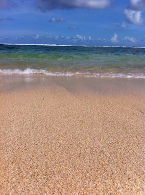 A picturesque beach scene with golden sand and clear water.