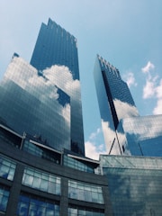 blue and white glass building under blue sky during daytime