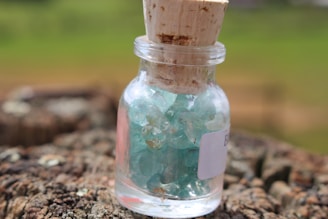 A jar of alta ritual shilajit resin on a wooden surface.