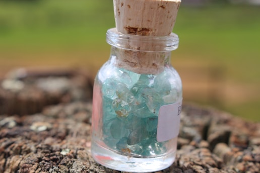 A jar of alta ritual shilajit resin on a wooden surface.