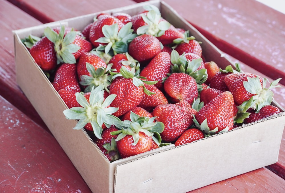 strawberries in brown cardboard box