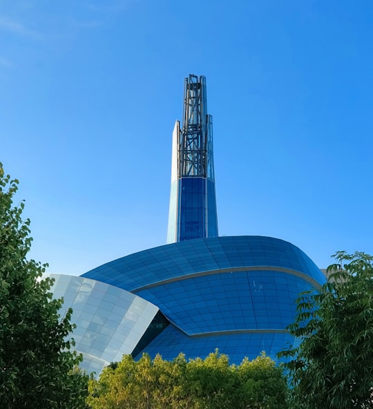 green trees near glass building during daytime in The Forks Canada