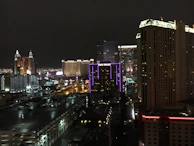 Nighttime cityscape of Sumter with glowing neon signs and lively streets.