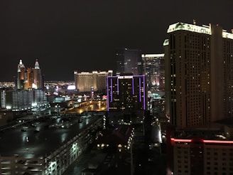 Nighttime cityscape showcasing illuminated skyscrapers and vibrant urban life.