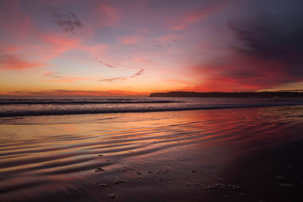 body of water during sunset