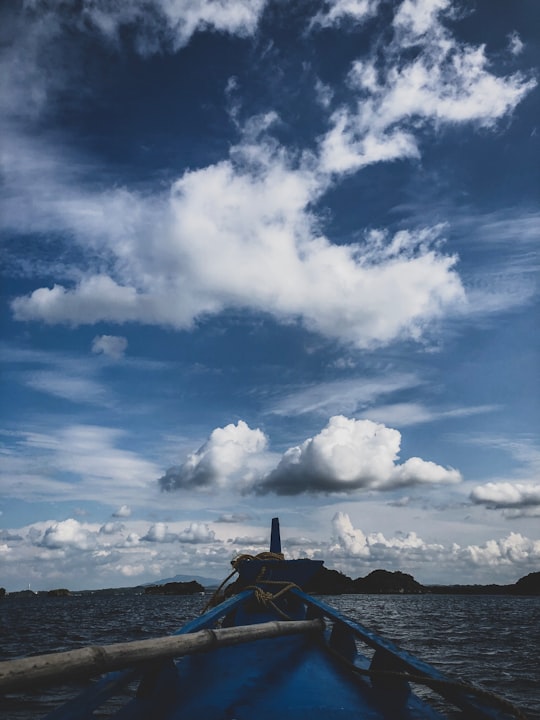 blue and white cloudy sky over the beach in Hundred Islands Philippines