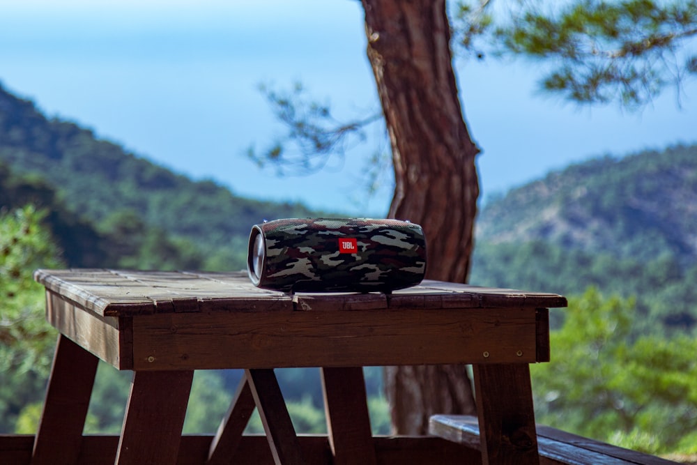 black and red sports car on brown wooden table