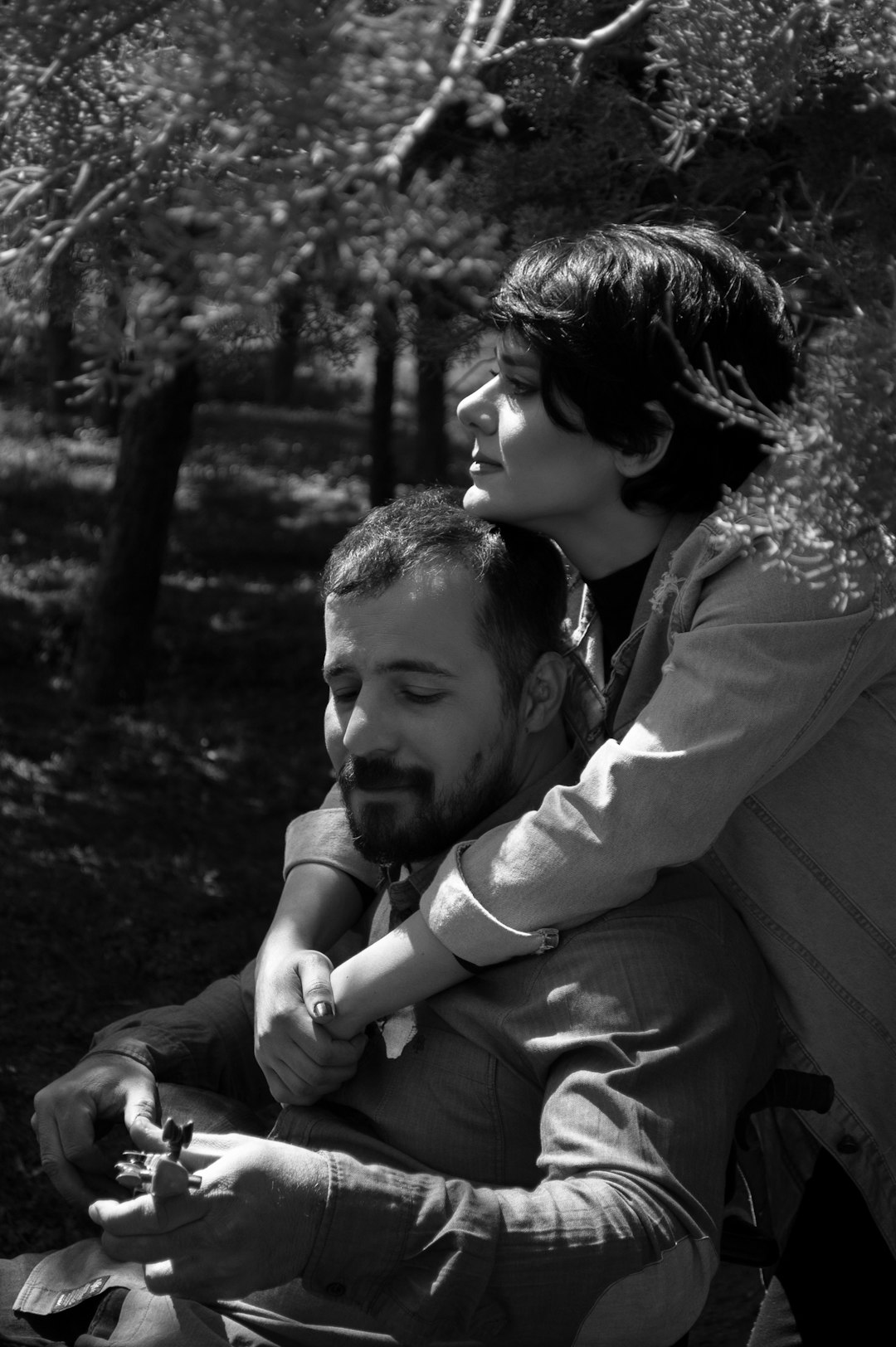 grayscale photo of man and woman kissing