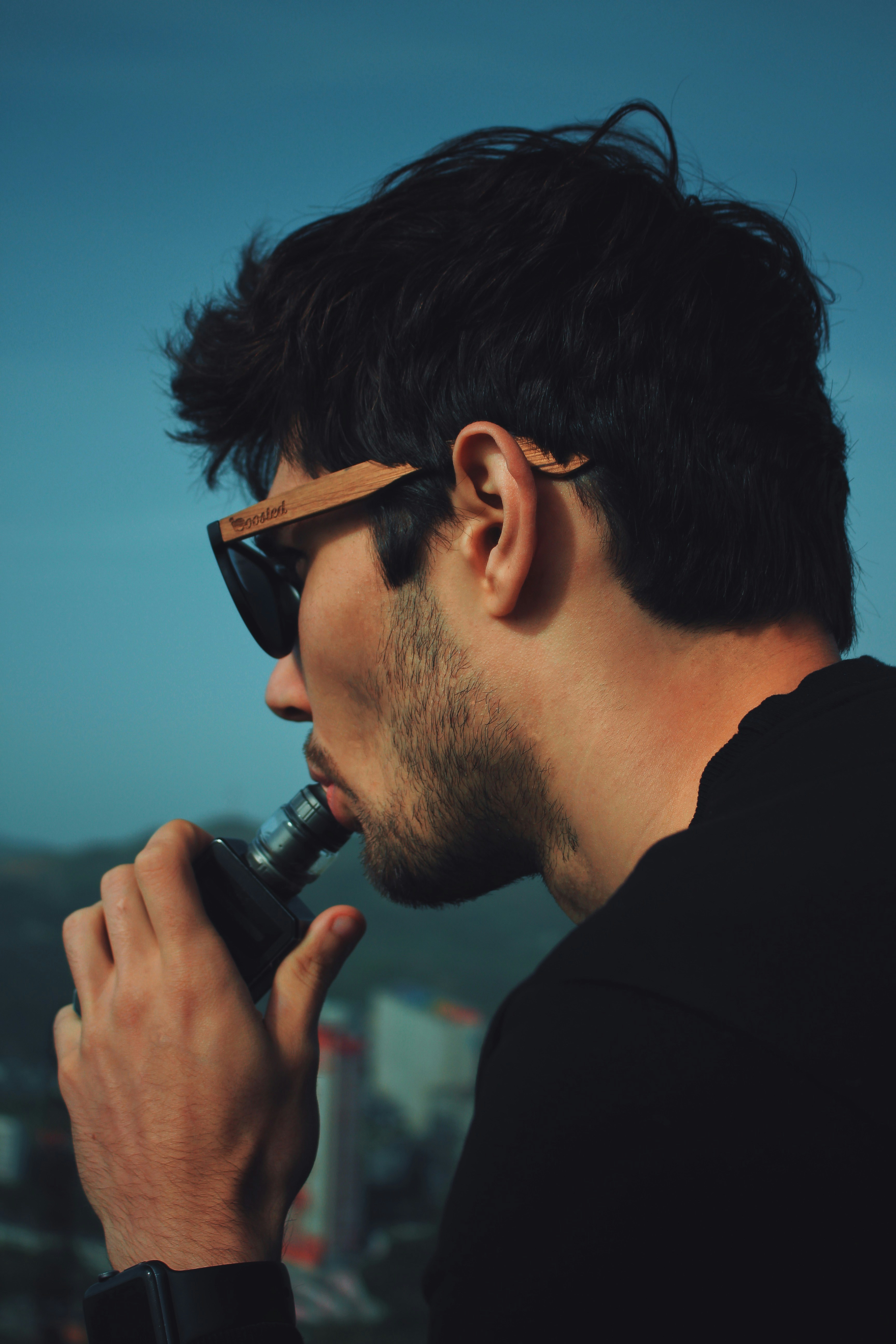 man in black shirt holding black microphone