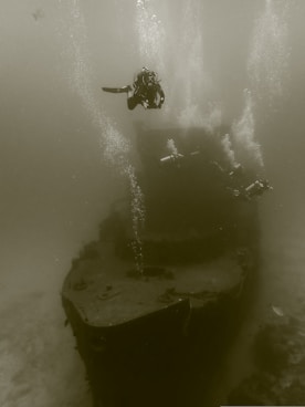 man in black wet suit in water