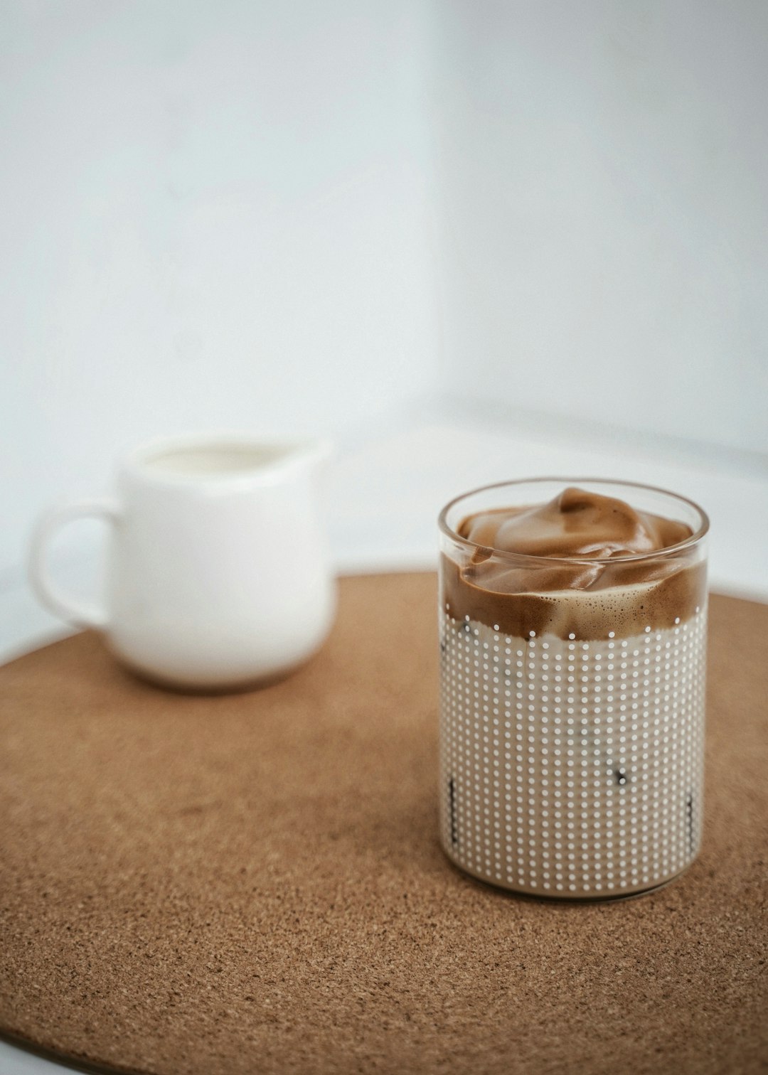 white ceramic mug with brown liquid inside