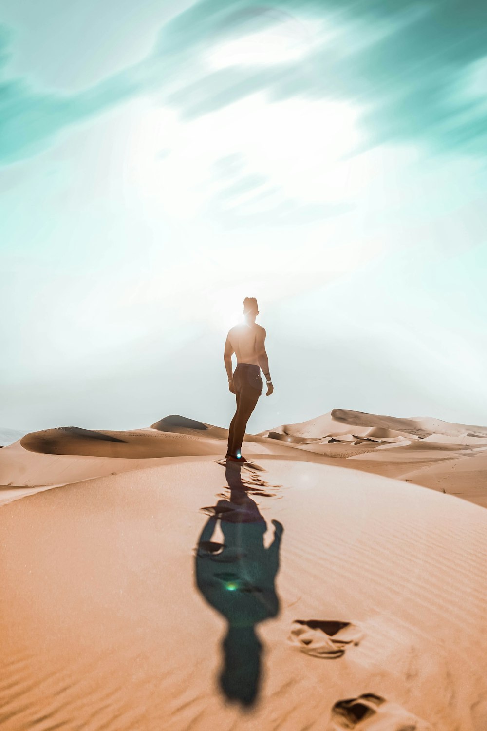 woman in white bikini walking on desert during daytime
