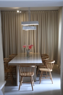 Elegant dining area with minimalist table and contemporary chairs.