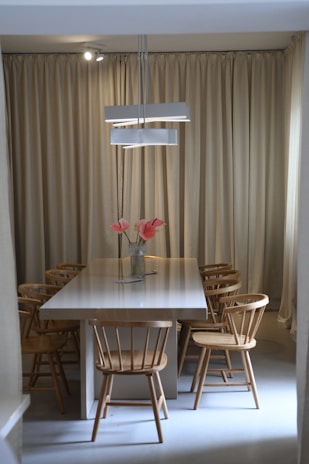 Elegant dining area with minimalist table and contemporary chairs.