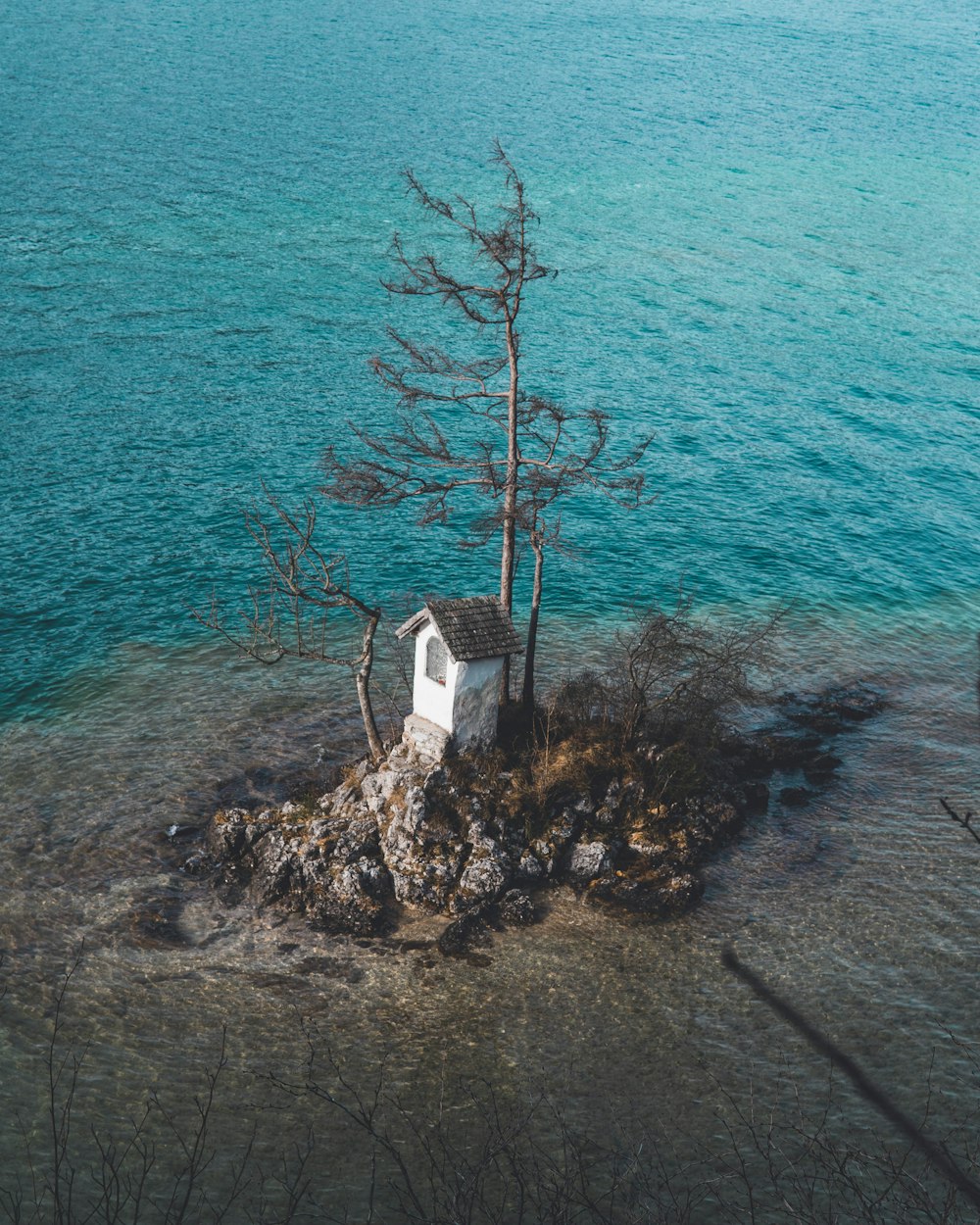 white and brown house near body of water during daytime