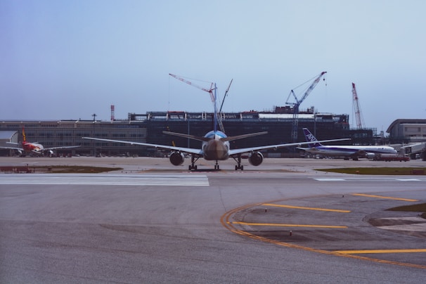 An airplane preparing for takeoff at a busy airport.
