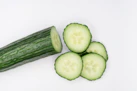 sliced cucumber on white surface