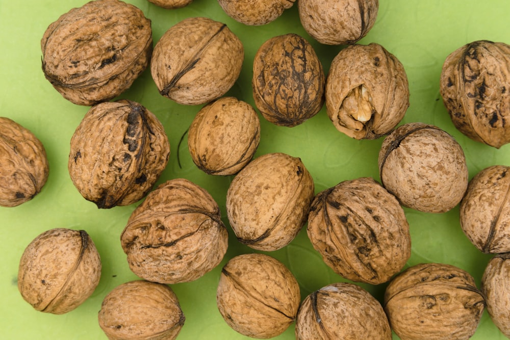 brown round fruit on green surface