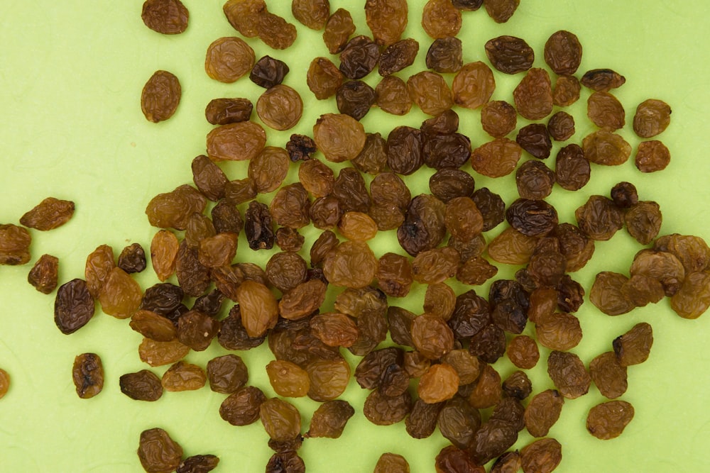 brown and black nuts on white surface