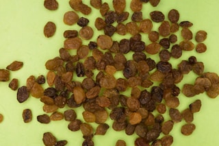 brown and black nuts on white surface