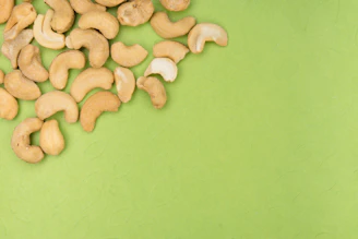 A vibrant photo of workers carefully sorting cashew kernels in a clean, modern processing facility.